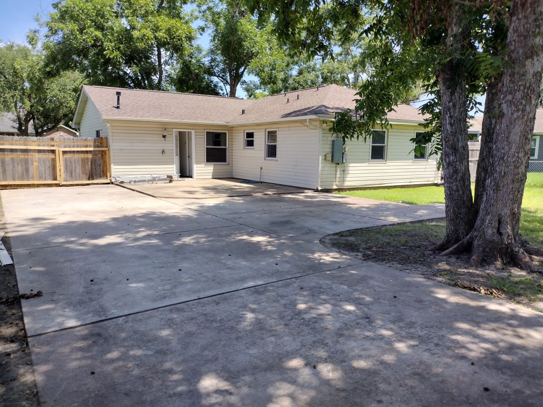 backyard view of house and double gate