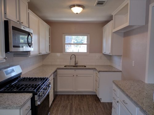 galley kitchen with all new cabinets, surfaces, appliances, fixtures, flooring