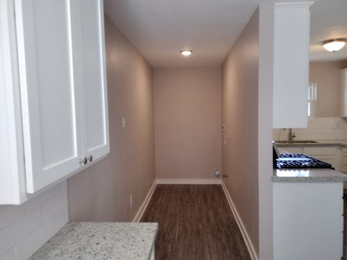 laundry room access off kitchen beyond newly built pantry